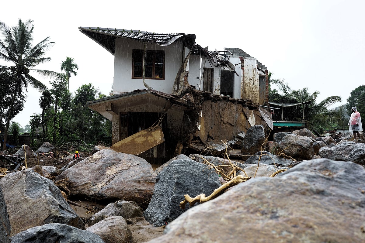 A rescuer stands next to a damaged houses on the 2nd day of operation following landslide in Wayanad district, Kerala, Wednesday, July 31, 2024  - PTI